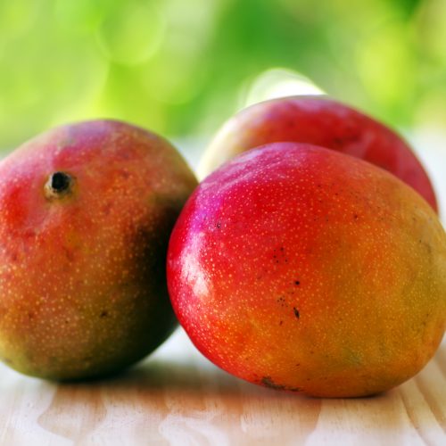 three mangoes fruits on table